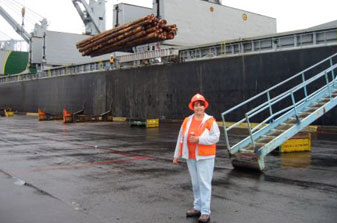 Photo of Marla in front of shipping vessel